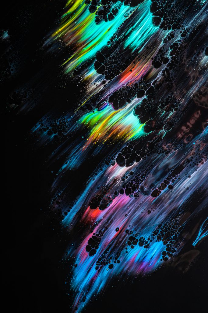 Colorful abstract art with dynamic paint streaks and bubbles on a dark background.